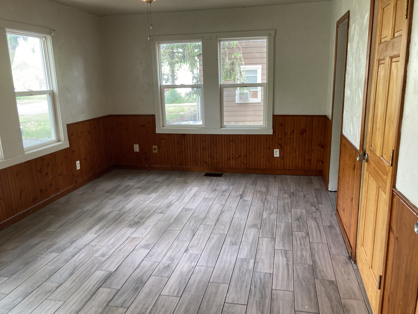 130 Edison Road Joliet, IL 60433 - Photo 3 of 9 an empty room with wooden floor and windows
