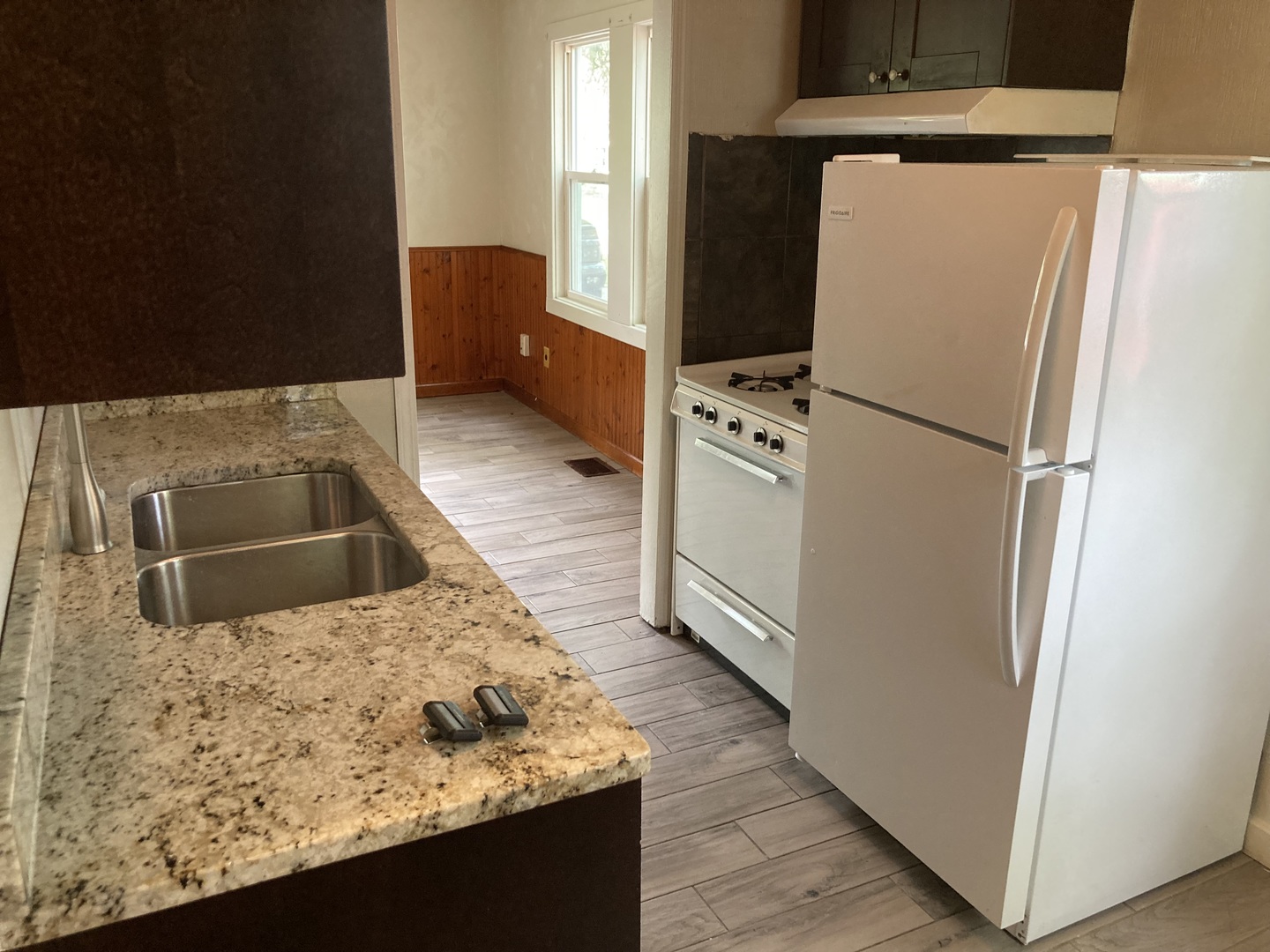 130 Edison Road Joliet, IL 60433 - Photo 4 of 9 a kitchen with stainless steel appliances granite countertop a refrigerator a stove and a sink with wooden floor