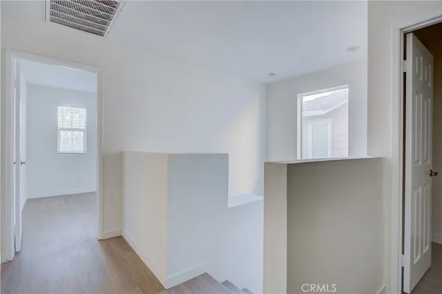 a view of hallway with wooden floor