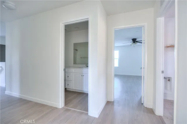 a view of an empty room and a ceiling fan