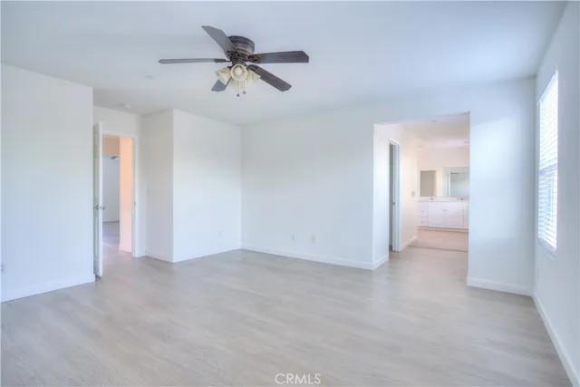 a spacious bathroom with a tub shower and mirror