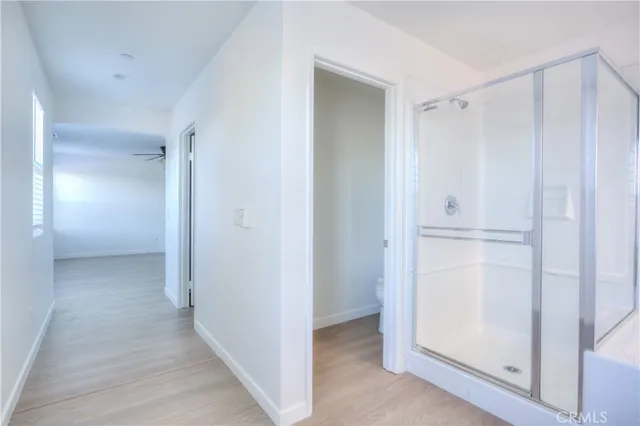 a spacious bathroom with a granite countertop sink a mirror and a bathtub