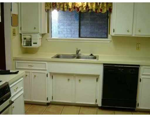 4558 Moonlake Ridge Drive Corpus Christi, TX 78413 - Photo 4 of 5 a kitchen with stainless steel appliances white cabinets and a sink