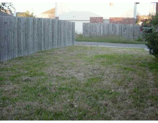 4558 Moonlake Ridge Drive Corpus Christi, TX 78413 - Photo 5 of 5 a view of a backyard with wooden fence