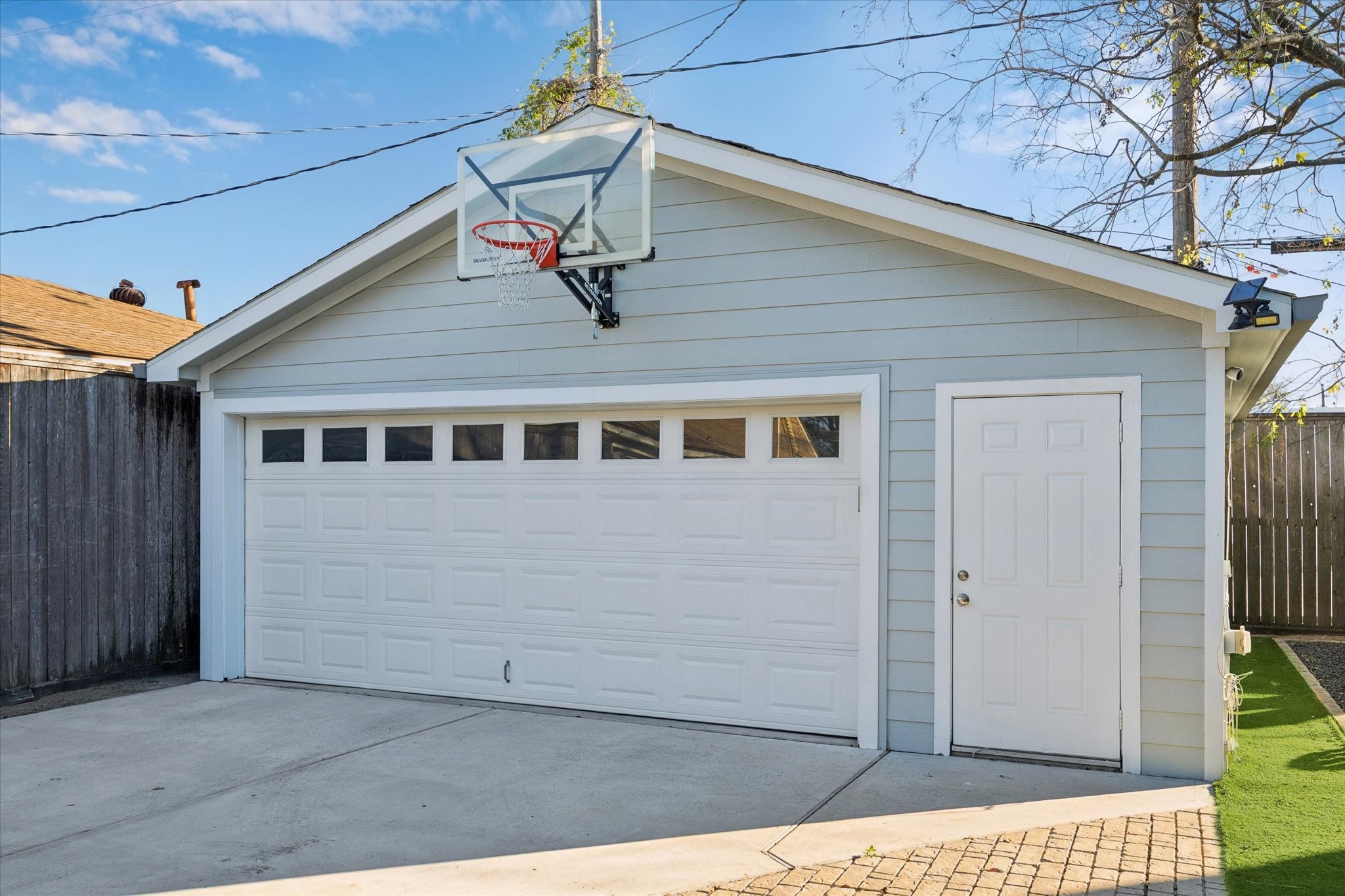 2109 Colquitt Street Houston, TX 77098 - Photo 27 of 28 The detached garage offers convenient parking and additional storage, with driveway access and a separate entry door.