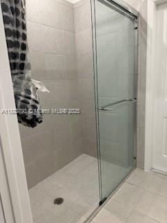 834 Southeast 26th Street, Unit STUDIO Homestead, FL 33035 - Photo 6 of 11 a bathroom with a glass shower door