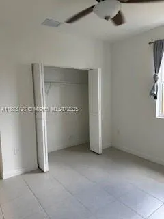 an empty room with entrance and windows