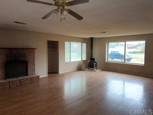 1366 Far Valley Road Campo, CA 91906 - Photo 4 of 26 wooden floor fireplace and windows in an empty room