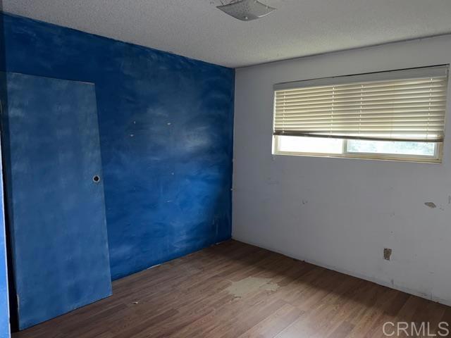 1366 Far Valley Road Campo, CA 91906 - Photo 7 of 26 a view of an empty room with wooden floor and a window