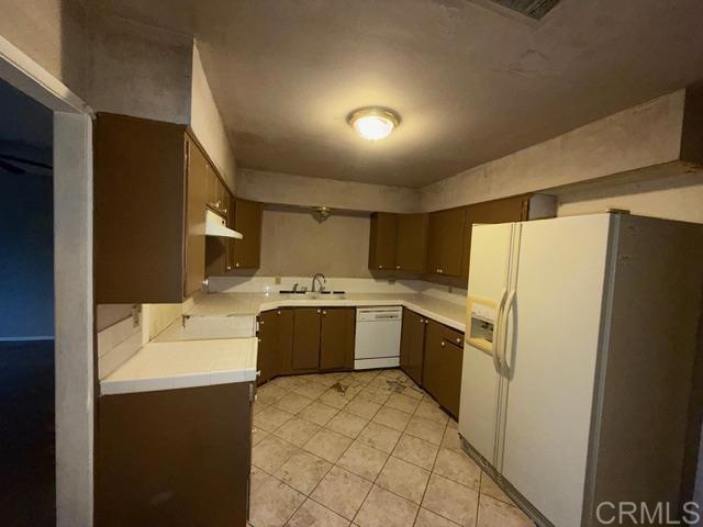1366 Far Valley Road Campo, CA 91906 - Photo 8 of 26 a large white kitchen with a sink a refrigerator and a stove