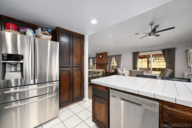 a kitchen with stainless steel appliances a refrigerator and microwave