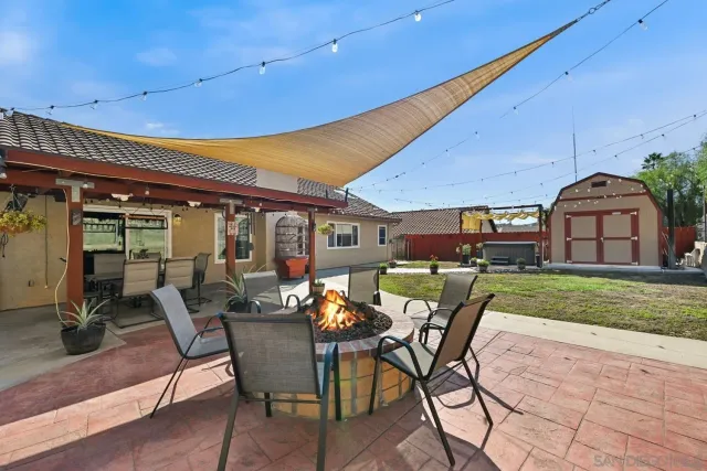 a view of a patio with table and chairs with wooden floor