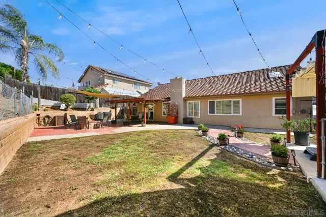 a view of a house with a yard patio and swimming pool