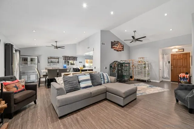 a living room with furniture and a wooden floor