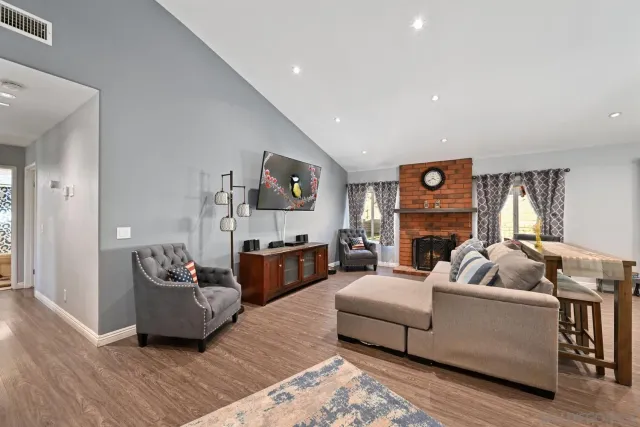 a living room with furniture and a fireplace