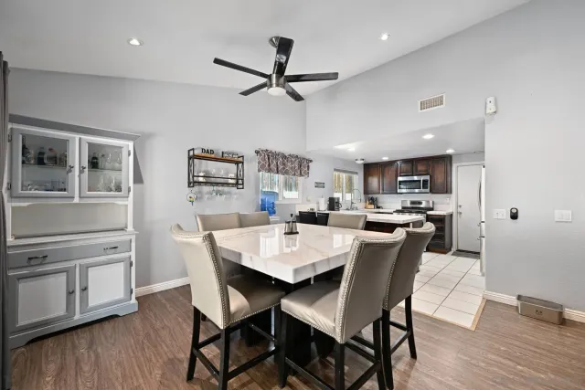 a view of a dining room with furniture and wooden floor