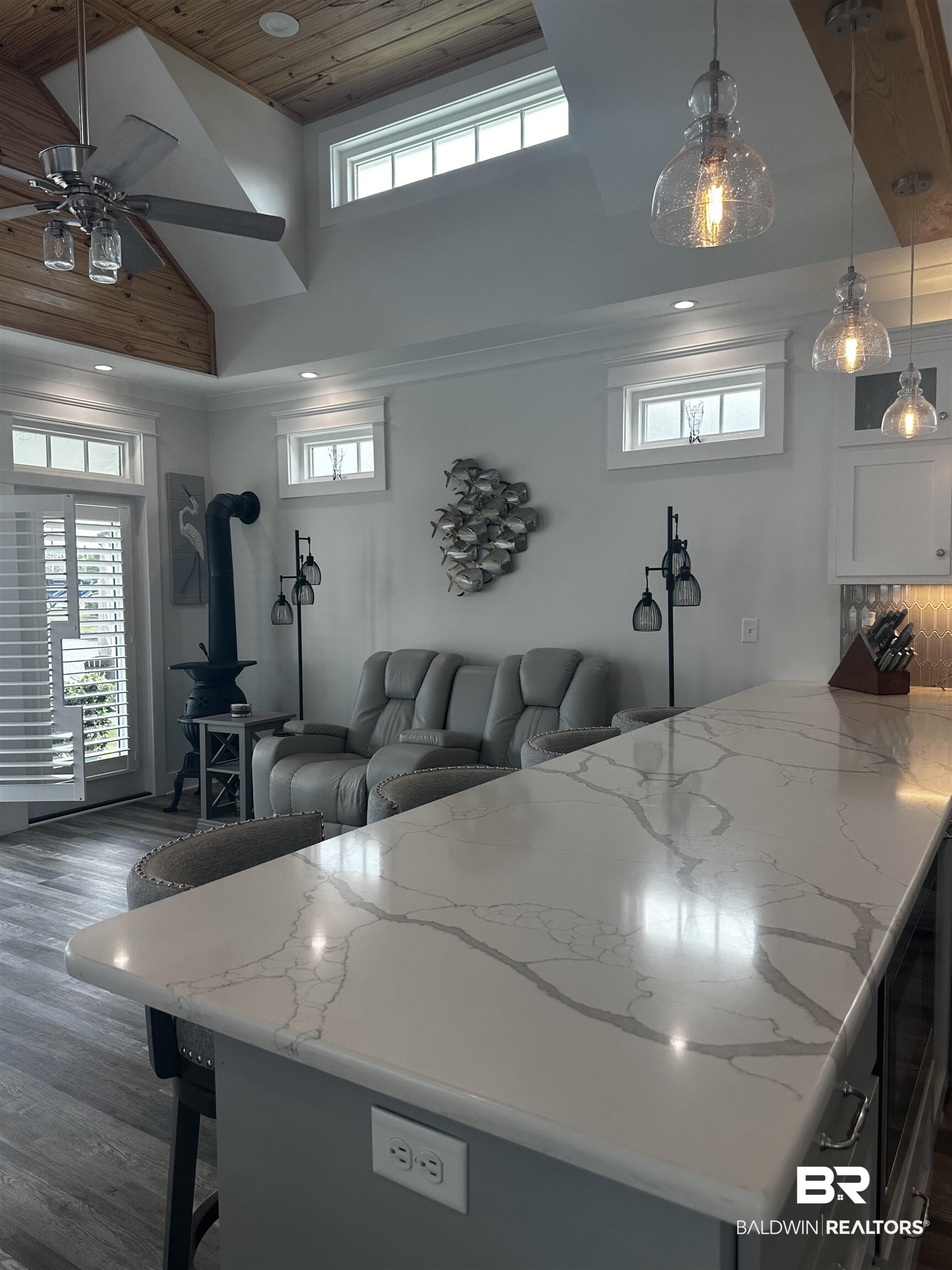 28058 Migratory Way, Unit 100 Elberta, AL 36530 - Photo 33 of 83 Living room featuring recessed lighting, a wood stove, dark wood-style flooring, high vaulted ceiling, and ceiling fan
