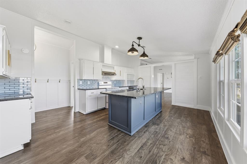 734 Northfork Road Royse City, TX 75189 - Photo 12 of 35 a kitchen with stainless steel appliances granite countertop a sink and cabinets