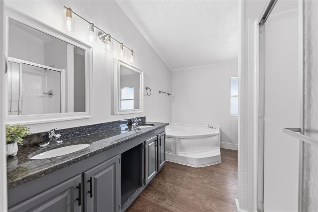 734 Northfork Road Royse City, TX 75189 - Photo 18 of 35 a bathroom with a granite countertop sink a toilet a mirror and bathtub