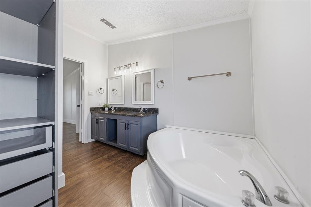 734 Northfork Road Royse City, TX 75189 - Photo 19 of 35 a spacious bathroom with a tub sink and mirror