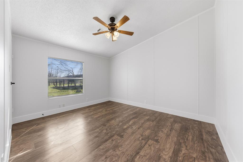 734 Northfork Road Royse City, TX 75189 - Photo 20 of 35 an empty room with wooden floor and windows