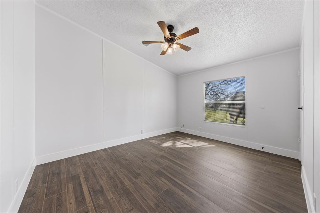 734 Northfork Road Royse City, TX 75189 - Photo 21 of 35 an empty room with wooden floor and windows