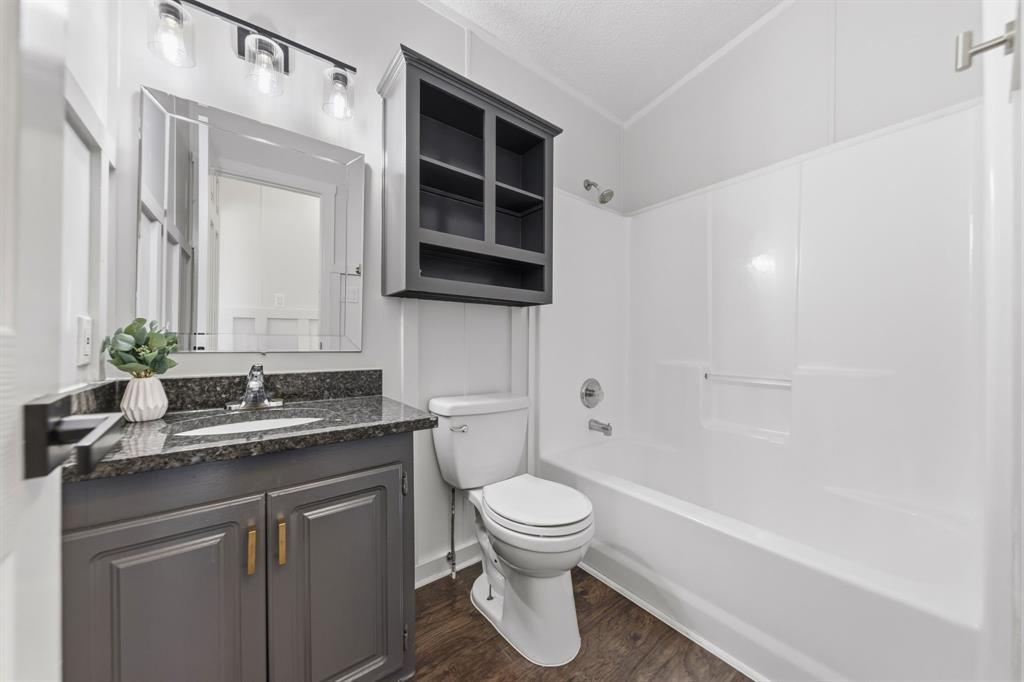734 Northfork Road Royse City, TX 75189 - Photo 22 of 35 a bathroom with a granite countertop sink toilet and shower