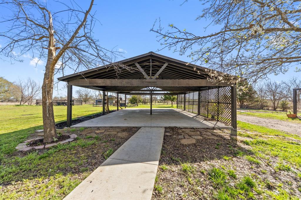 734 Northfork Road Royse City, TX 75189 - Photo 28 of 35 a view of a patio with a table chairs and a backyard