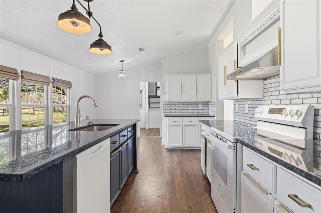 734 Northfork Road Royse City, TX 75189 - Photo 10 of 35 a kitchen with stainless steel appliances granite countertop a stove a sink and a microwave