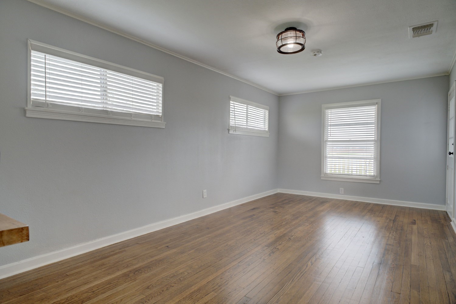 2940 Rabbs Prairie Road La Grange, TX 78945 - Photo 14 of 39 an empty room with wooden floor and windows