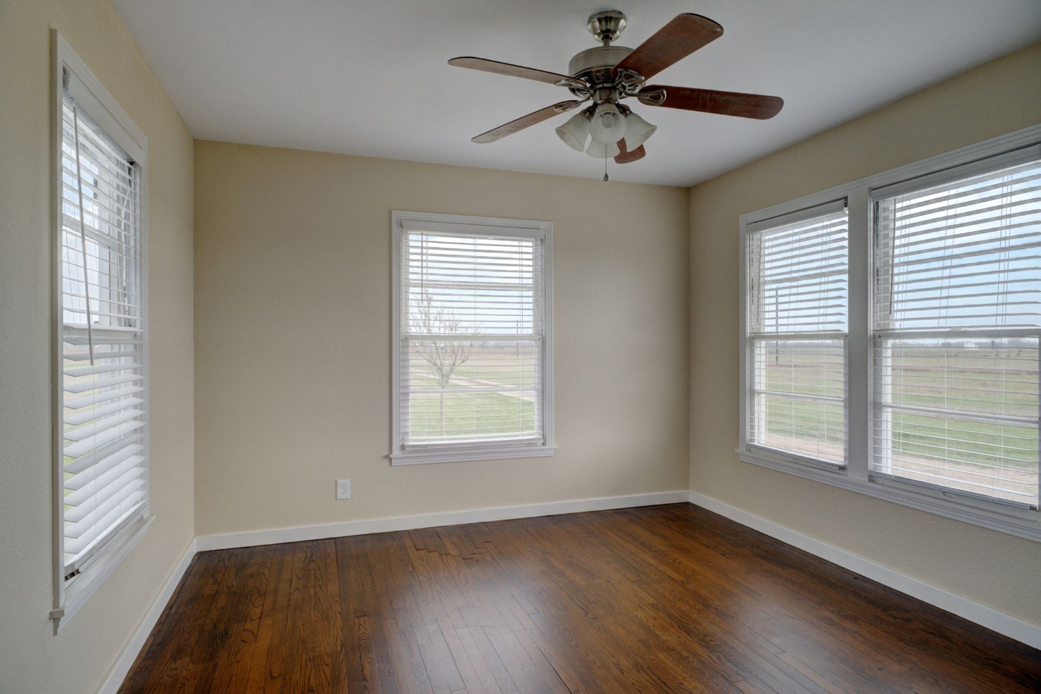 2940 Rabbs Prairie Road La Grange, TX 78945 - Photo 18 of 39 a view of an empty room with wooden floor and a window