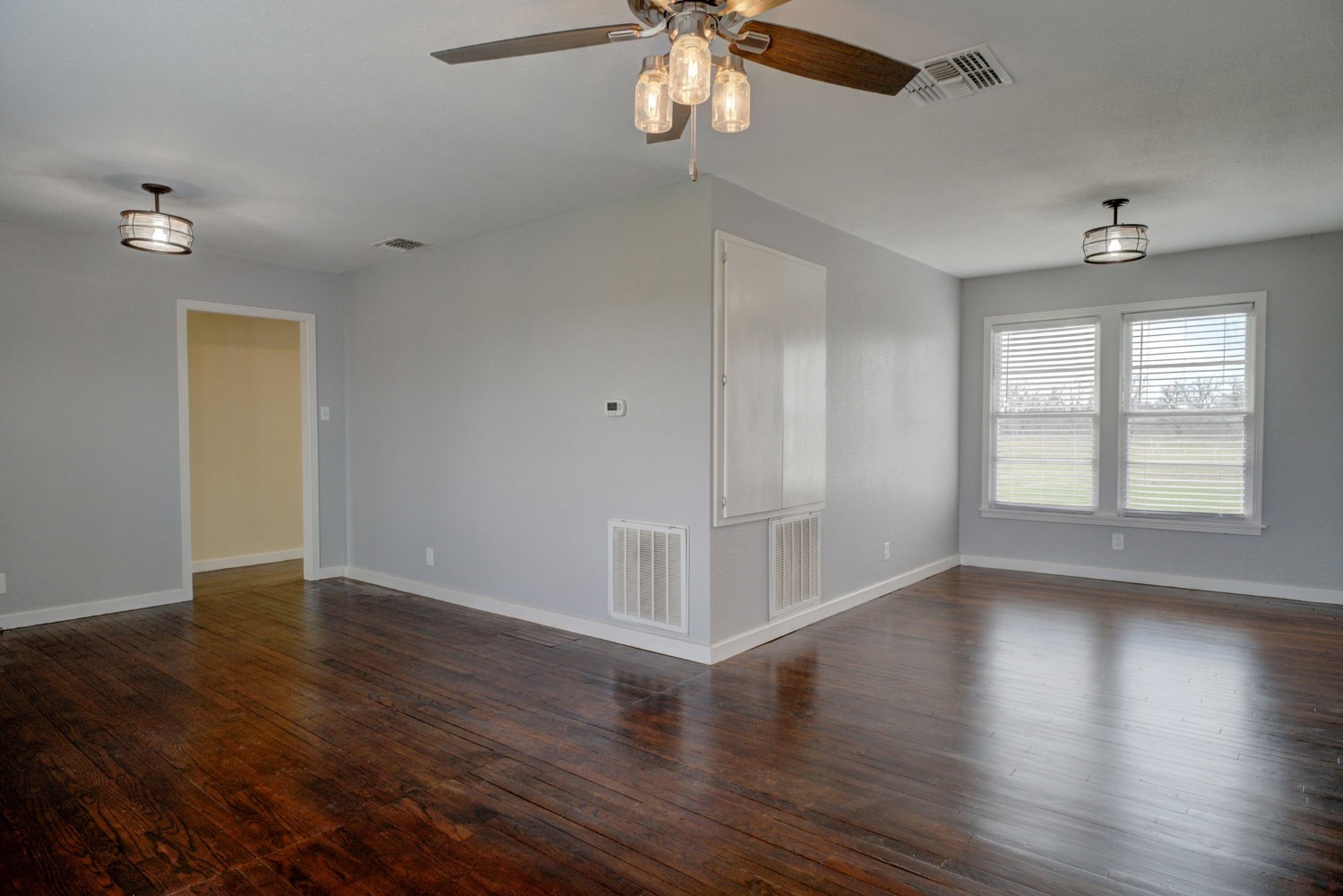 2940 Rabbs Prairie Road La Grange, TX 78945 - Photo 9 of 39 a view of an empty room with wooden floor and a window
