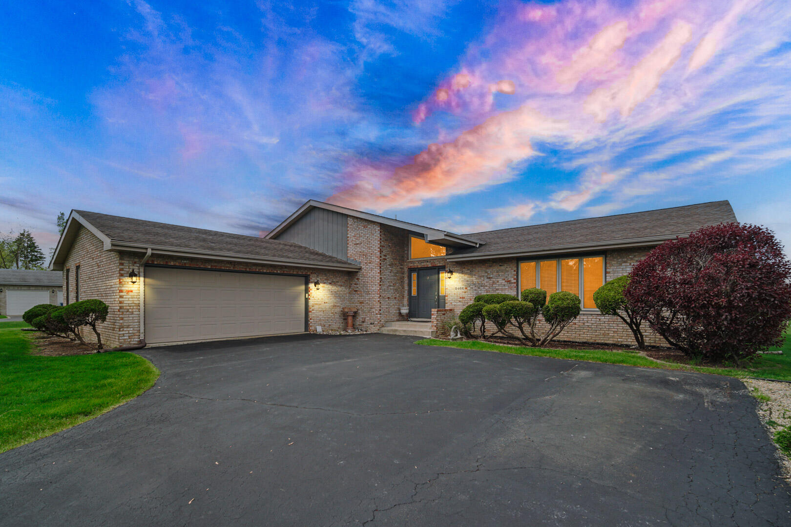 a front view of a house with a yard and garage