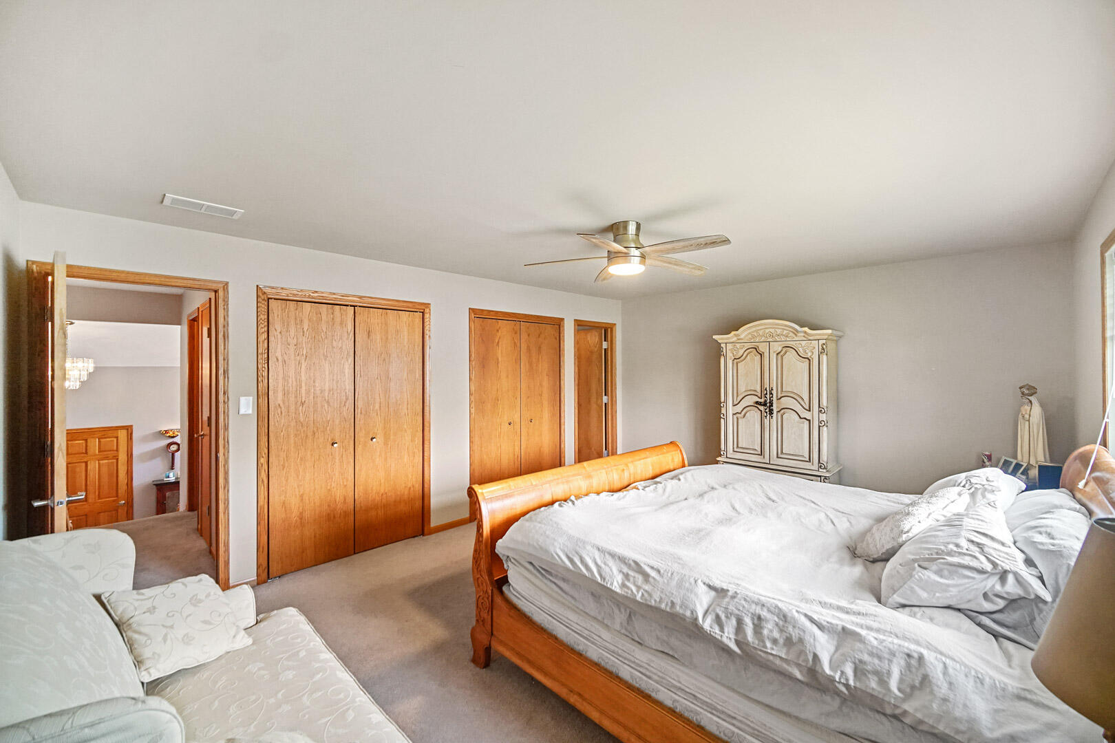 8466 Christopher Drive St. John, IN 46373 - Photo 13 of 23 a bedroom with a large bed and a chandelier