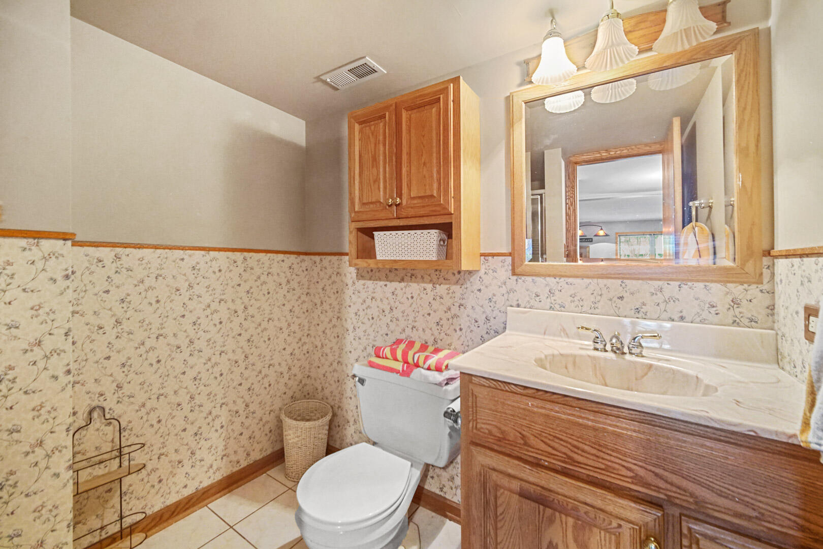 8466 Christopher Drive St. John, IN 46373 - Photo 21 of 23 a bathroom with a sink a toilet and a mirror