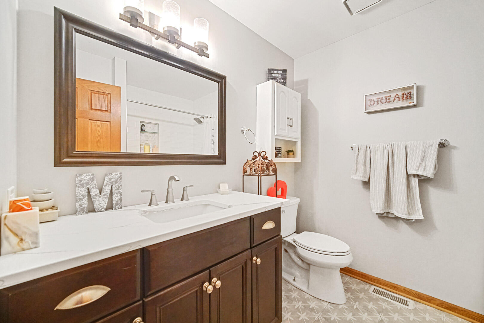 8466 Christopher Drive St. John, IN 46373 - Photo 10 of 23 a bathroom with a sink vanity mirror and toilet
