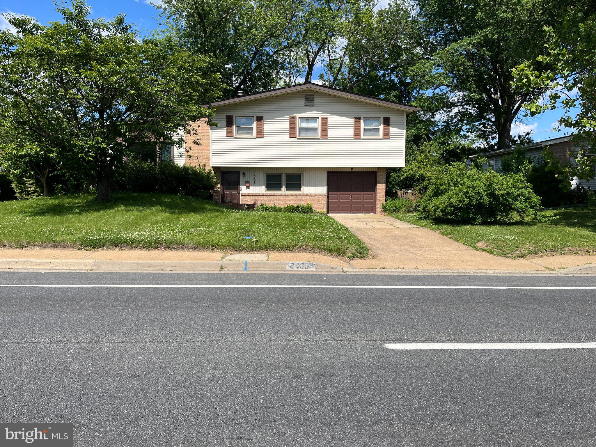 2405 Limestone Road Wilmington, DE 19808 - Photo 1 of 40 a front view of a house with a yard and garage
