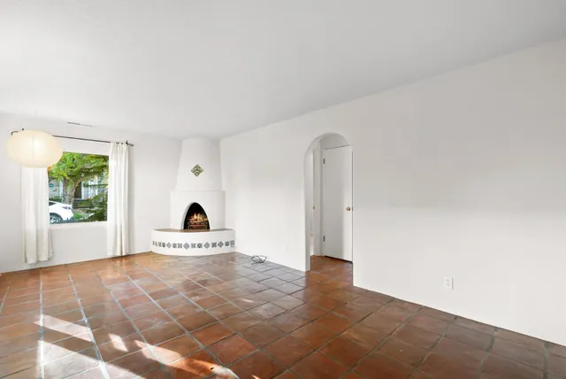 a view of a livingroom with wooden floor and a large window