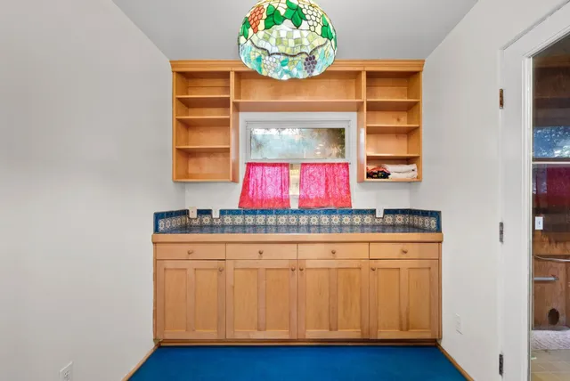 a view of kitchen with stainless steel appliances granite countertop cabinets and wooden floor