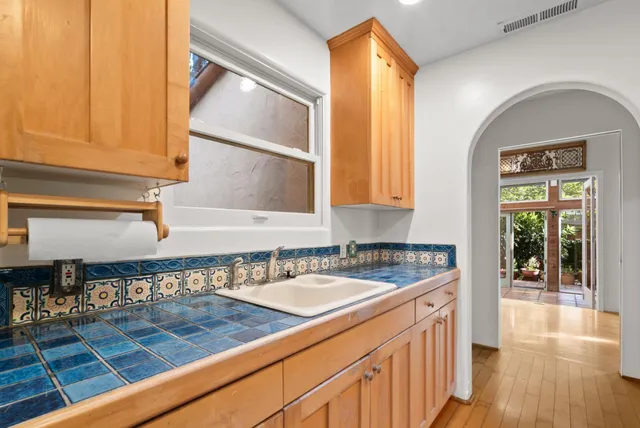 a kitchen with stainless steel appliances granite countertop a sink and a stove