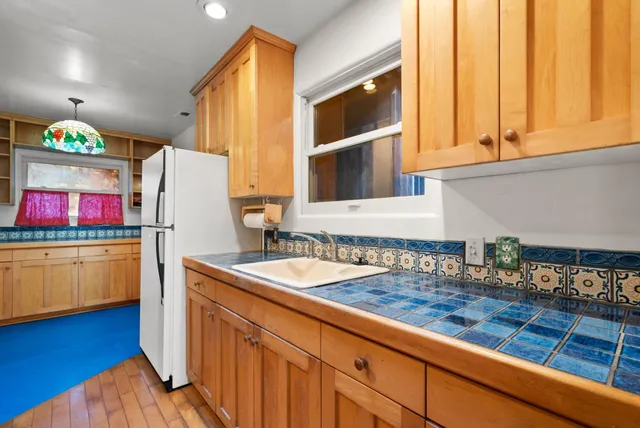 a kitchen with stainless steel appliances granite countertop a stove a sink and a white cabinets