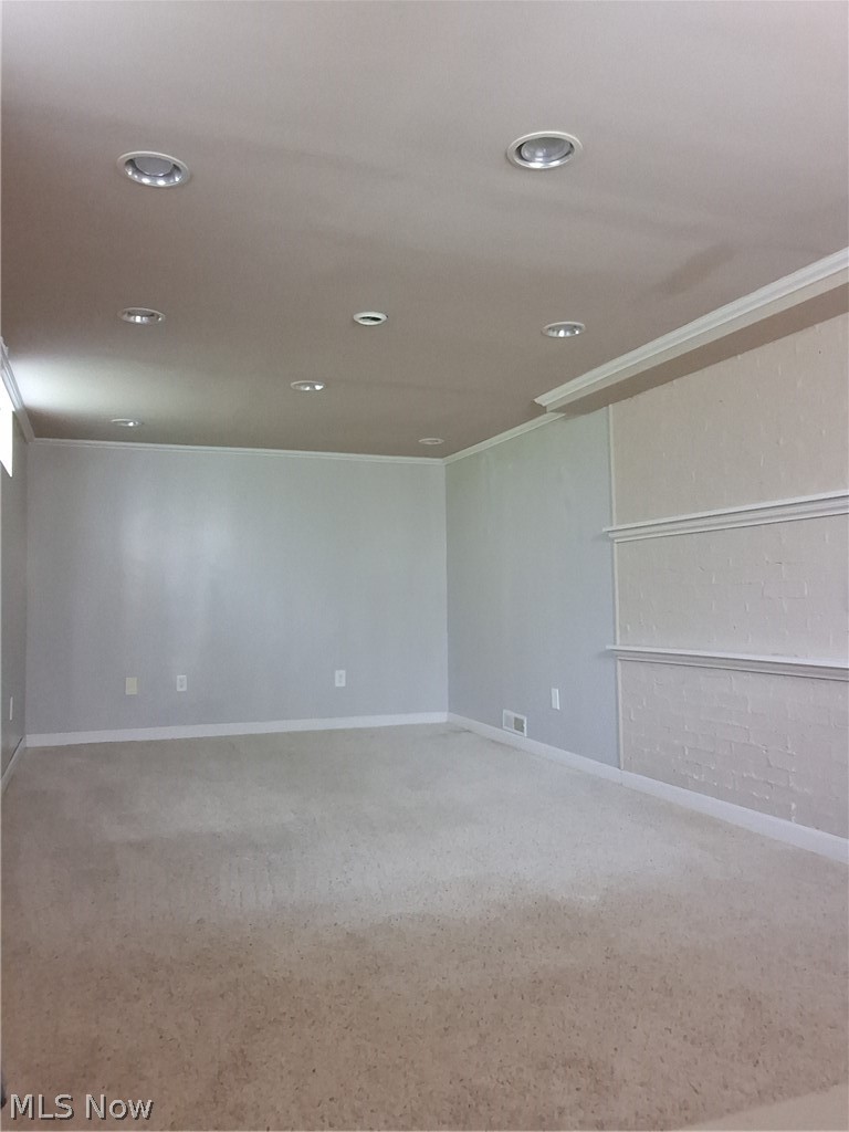 236 Bowland Road Mansfield, OH 44907 - Photo 18 of 34 Spacious room featuring neutral carpet flooring, recessed lighting, white baseboards, and white crown molding