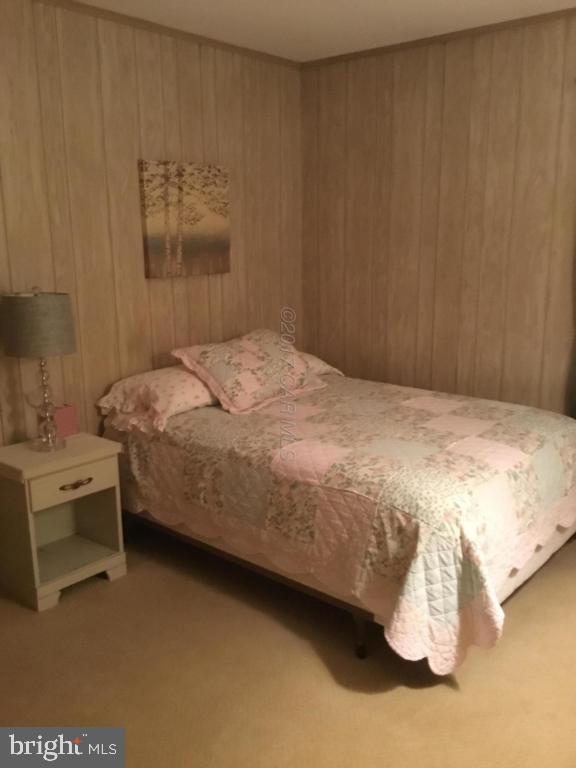 30 Brookside Road Ocean Pines, MD 21811 - Photo 11 of 27 a bedroom with a bed and a table