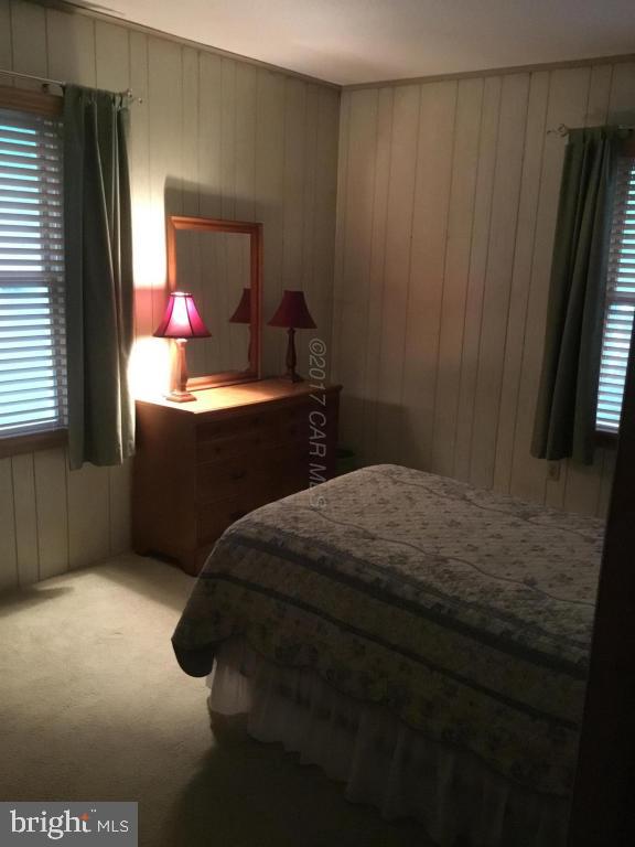 30 Brookside Road Ocean Pines, MD 21811 - Photo 12 of 27 a bedroom with a bed dresser and a window