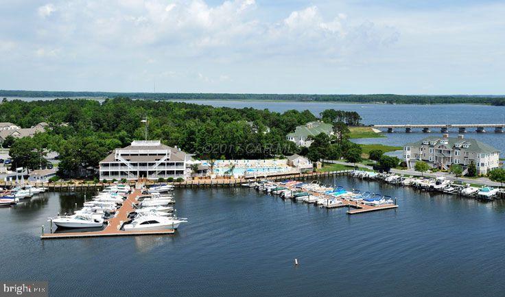 30 Brookside Road Ocean Pines, MD 21811 - Photo 19 of 27 a view of a lake with boats and trees in the background