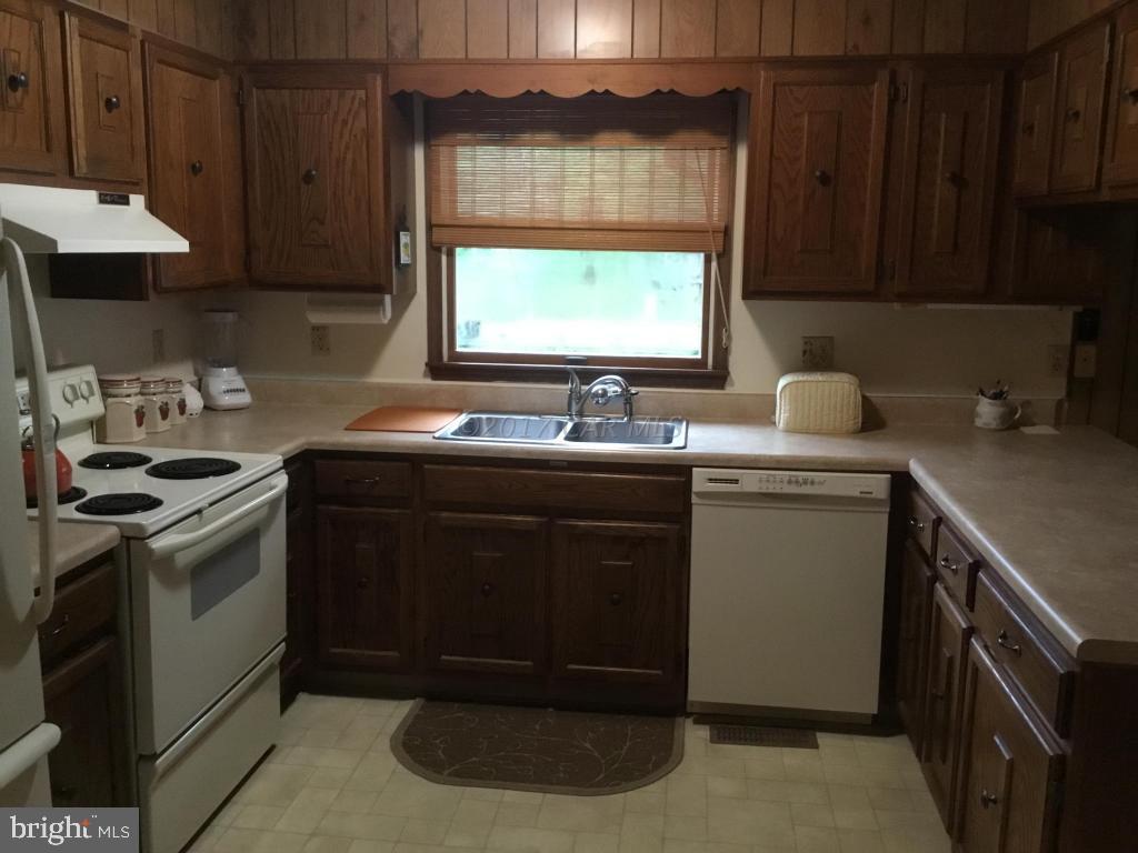 30 Brookside Road Ocean Pines, MD 21811 - Photo 6 of 27 a kitchen with a sink stove and cabinets