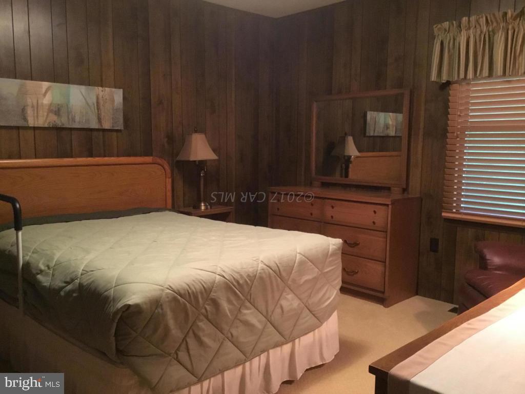 30 Brookside Road Ocean Pines, MD 21811 - Photo 9 of 27 a bedroom with a bed and a night stand