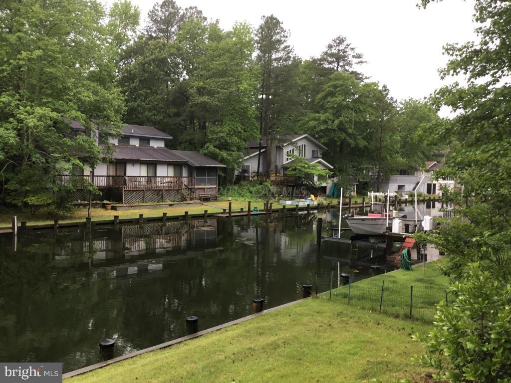 30 Brookside Road Ocean Pines, MD 21811 - Photo 10 of 27 a backyard of a house with lots of green space and lake view