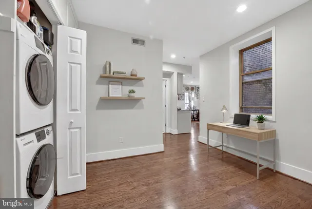 a view of a hallway with washer and dryer