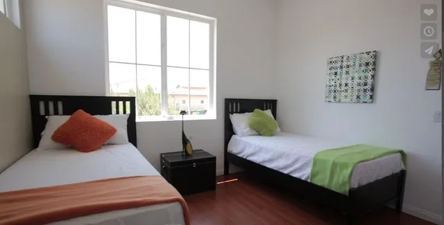 a bedroom with a bed and a window